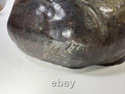 Vintage brutalist studio pottery seated Asian monk with pointed hat signed